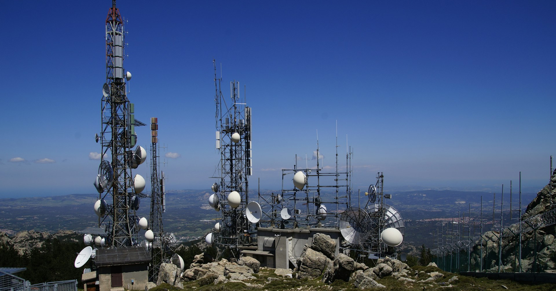 a group of cell towers sitting on top of a mountain